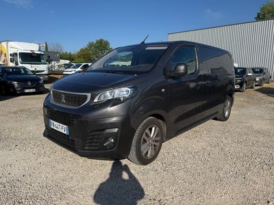 a black van parked in a parking lot next to other vehicles