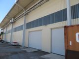 a large warehouse building with a lot of garage doors