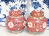pair of red and blue vases sitting on top of a white table