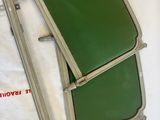 two pieces of luggage sitting on top of a white sheet