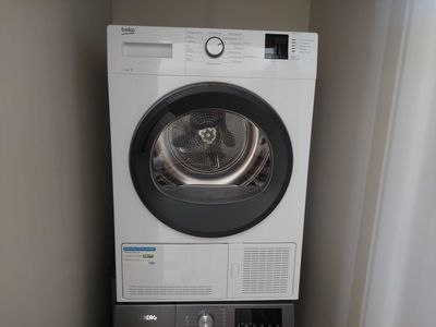 a washer and dryer in the corner of a room