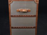 an old suitcase with three drawers on a black background
