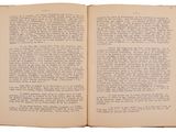 an open book with a page in it on a white surface