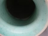 a blue vase that is sitting on top of a table