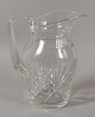 a glass pitcher that is sitting on a table