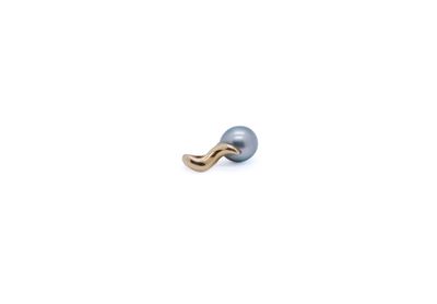 an image of a single pearl earring on a white background