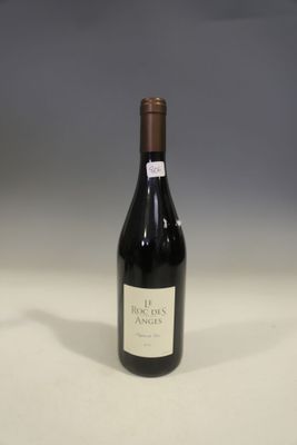 the bottle of red wine is sitting on the table