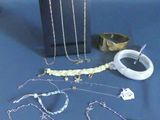several pieces of jewelry sitting on a table with a blue background