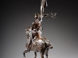 bronze statue of a man on a horse with a spear on his head