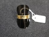 a ring that is on a black surface with a price tag
