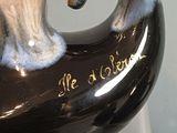 a black vase with a handle that says be a winner