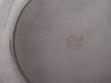 a close up view of a white vase with a brown writing on it