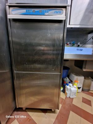 a stainless steel refrigerator sitting in a kitchen next to a counter