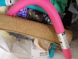 a pink hose sitting in a basket on a table