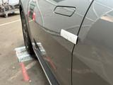 a car with a sticker on it parked in a parking lot