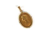 a close up of a gold coin with a woman ' s face on it