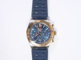 wrist watch on a white surface with a blue strap