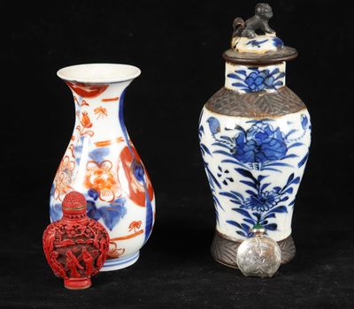 two vases sitting next to each other on a black background