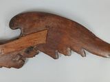 an image of a wooden bird with a wooden arrow on it ' s back