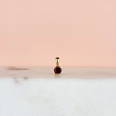a small bottle of perfume sitting on a table
