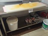 a picture of a dirty kitchen with a sink and a trash can