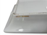 a white porcelain bowl with a yellow label on it