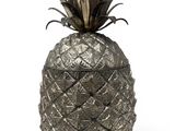 a close up of a metal pineapple on a white background