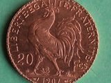 an image of a coin with a rooster on it on a green surface