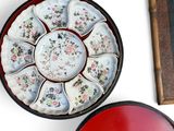 two bowls and a plate on a table next to a picture