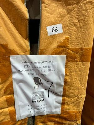 a sign on the back of a chair in a store