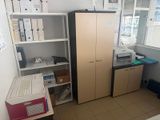 une pièce équipée d'un bureau, d'armoires et d'un ordinateur