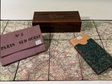 a map and a wallet on the floor next to a box