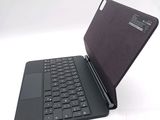 a black laptop with a black keyboard on a white surface