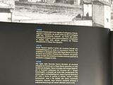 an open book with a picture of a city in it