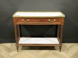 a small wooden table with marble top on a chevroned floor