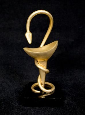 a gold sculpture of a swan on a black base