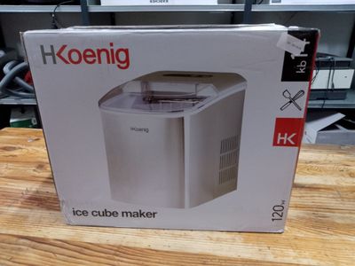 packaging of a white ice cube maker sitting on top of a wooden table