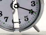 a close up of a clock with green numbers on it