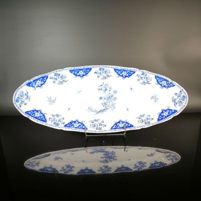 a blue and white plate on a black table