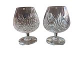 pair of crystal goblets on stand on white background