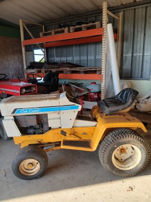 a small yellow tractor parked in a garage