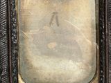 an old photo of a woman in a dress is shown in a frame