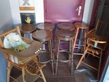 four wooden chairs and a table in a small room