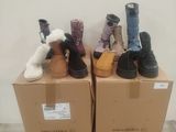 several pairs of shoes are stacked on top of boxes in a room