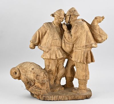 carved wooden sculpture of two men with a dog and a sheep