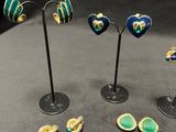 three pairs of earrings and a pair of earrings on a stand