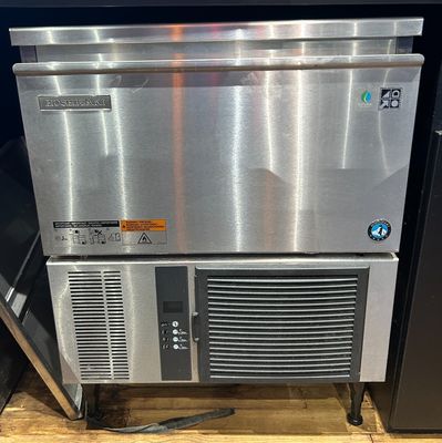 a stainless steel dishwasher and a refrigerator in a store