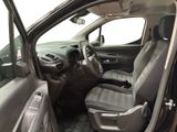the interior of a car with the door open and the driver ' s seat down