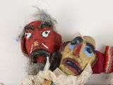 two puppets of a man and a woman on a shelf