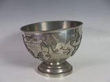 a silver cup that is sitting on a table